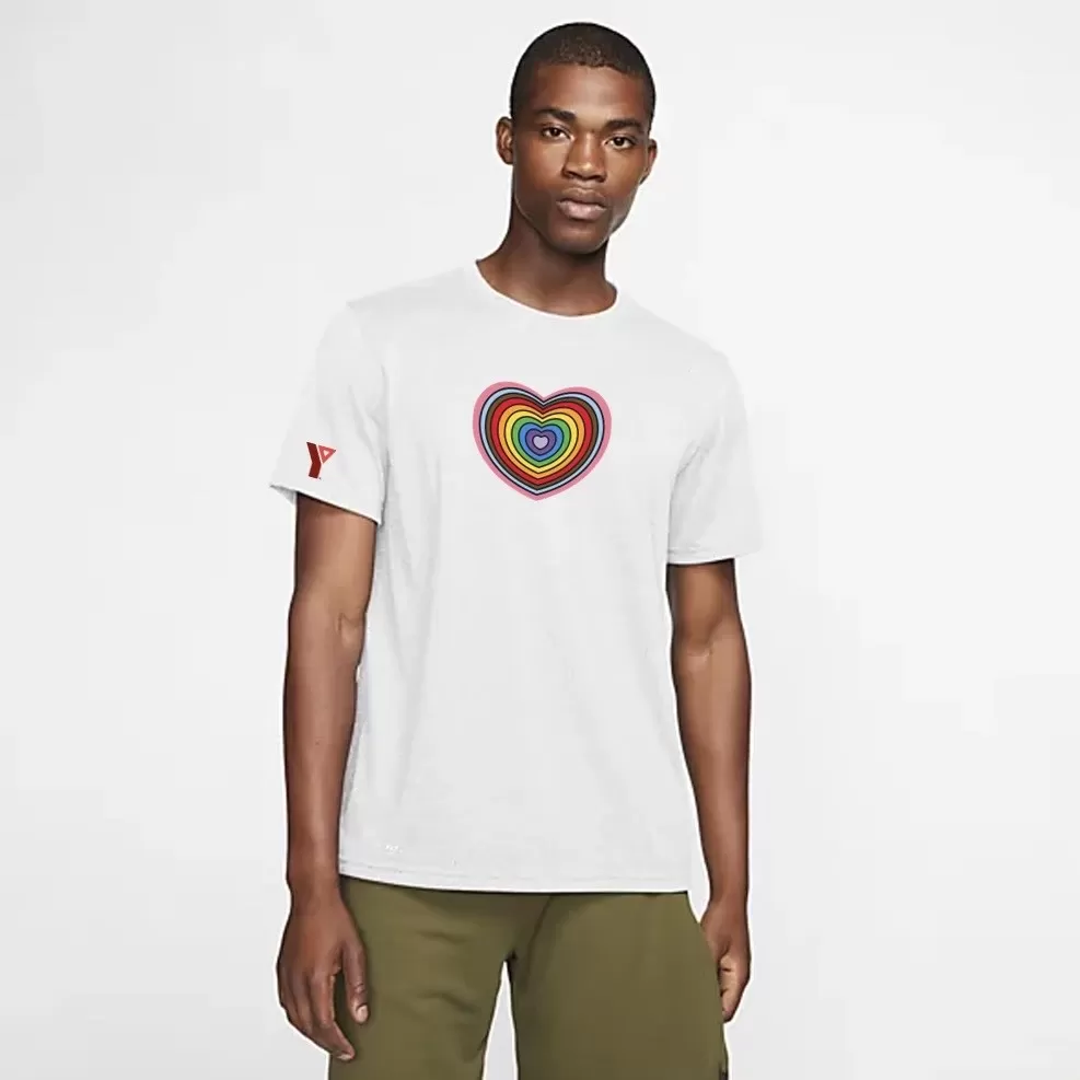 Adult wearing white t-shirt with rainbow heart on chest and YMCA logo on sleeve