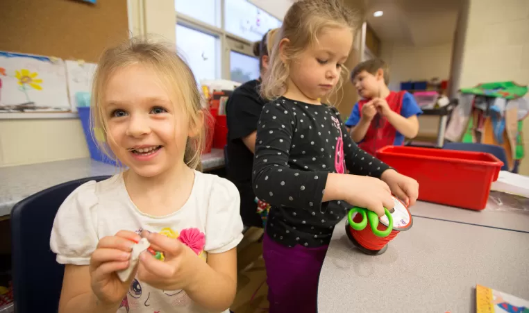 School age girls making crafts