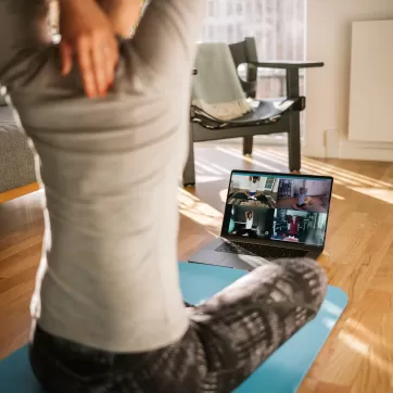 Adult stretching in front of computer